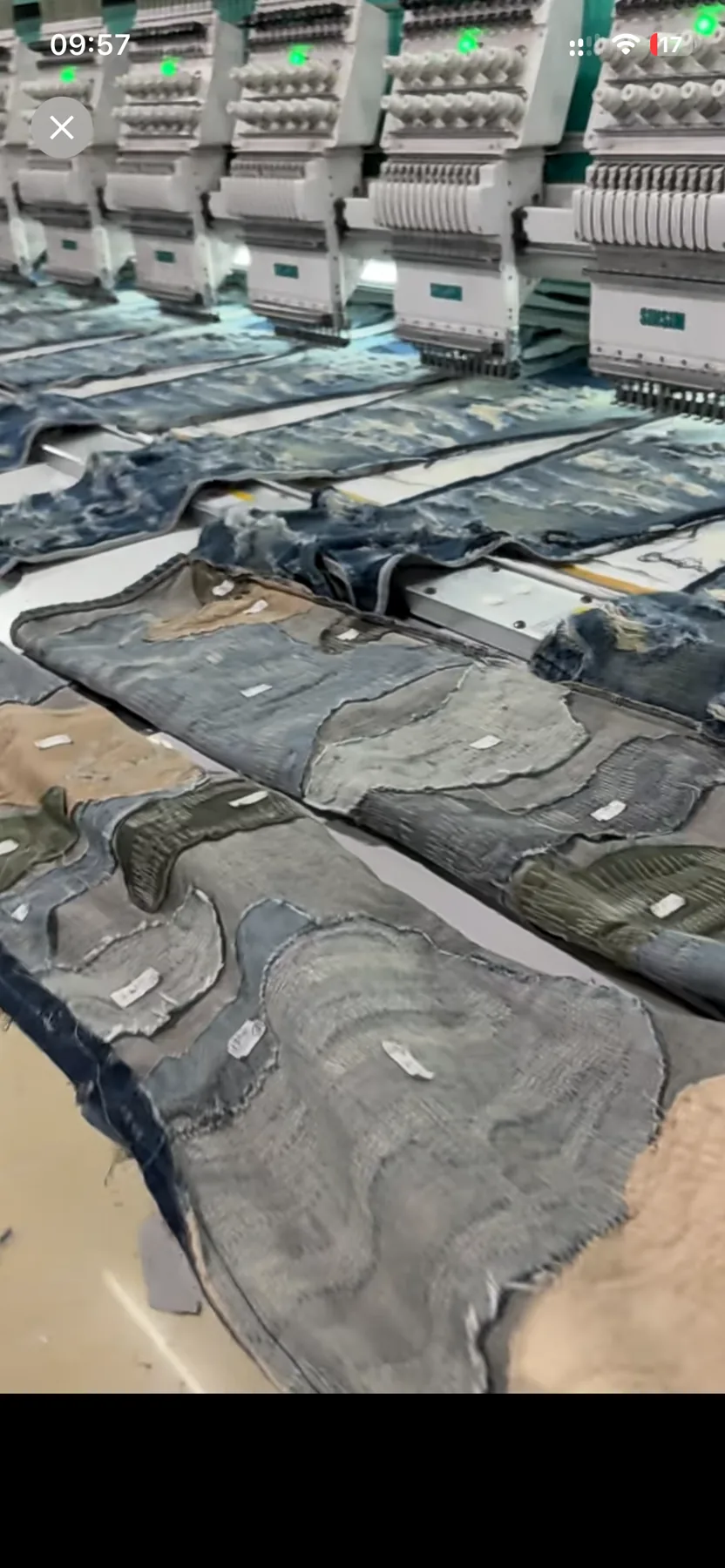 Close view of denim panels aligned on an embroidery machine bed