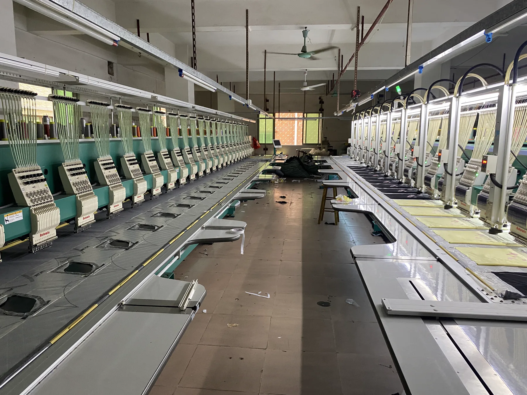 Embroidery factory floor with rows of multi-head embroidery machines