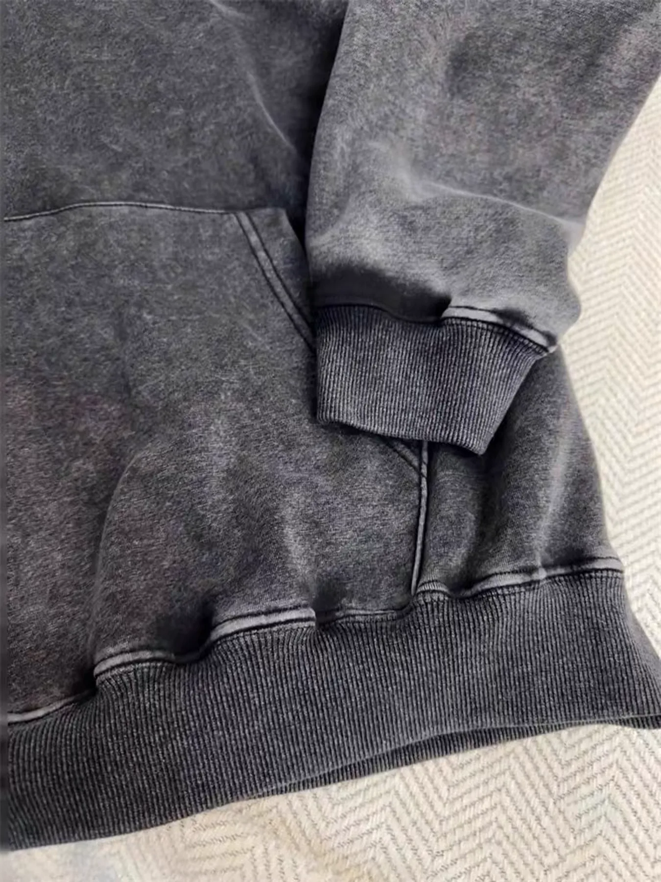 Washed sweatshirt pocket hem and cuff detail
