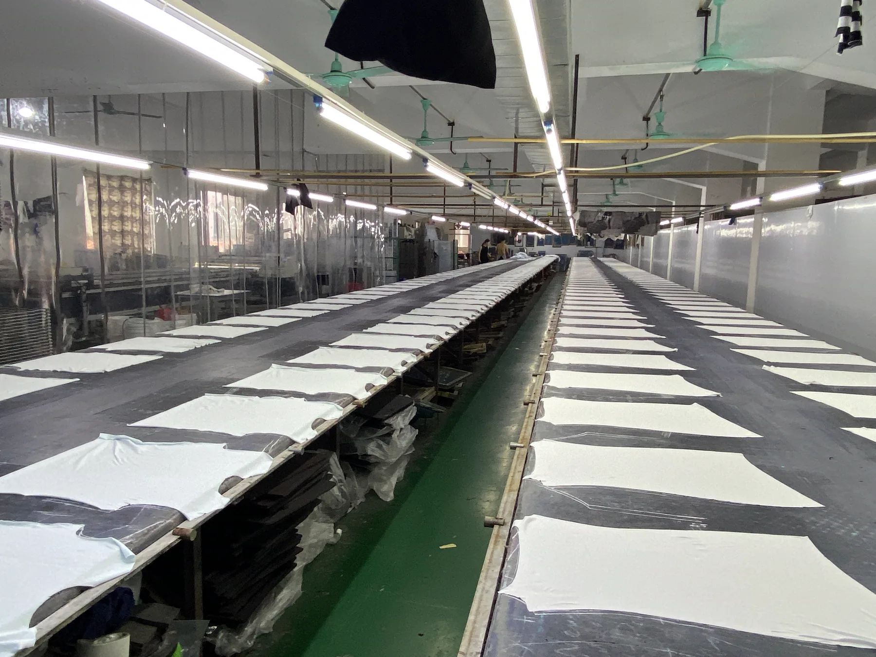 Prepared white garment panels aligned along long print beds