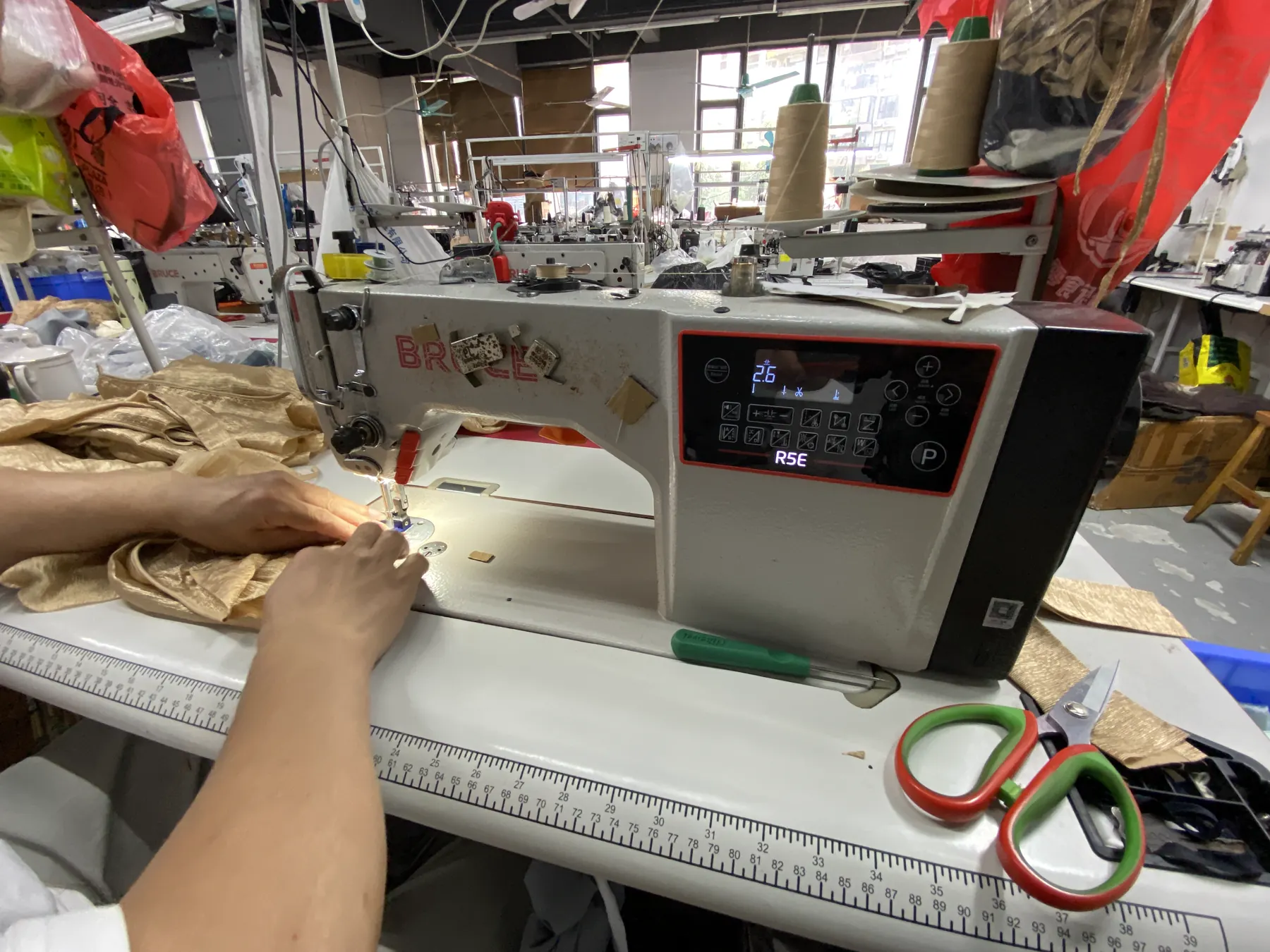 Garment fabric and construction detail at a sewing station