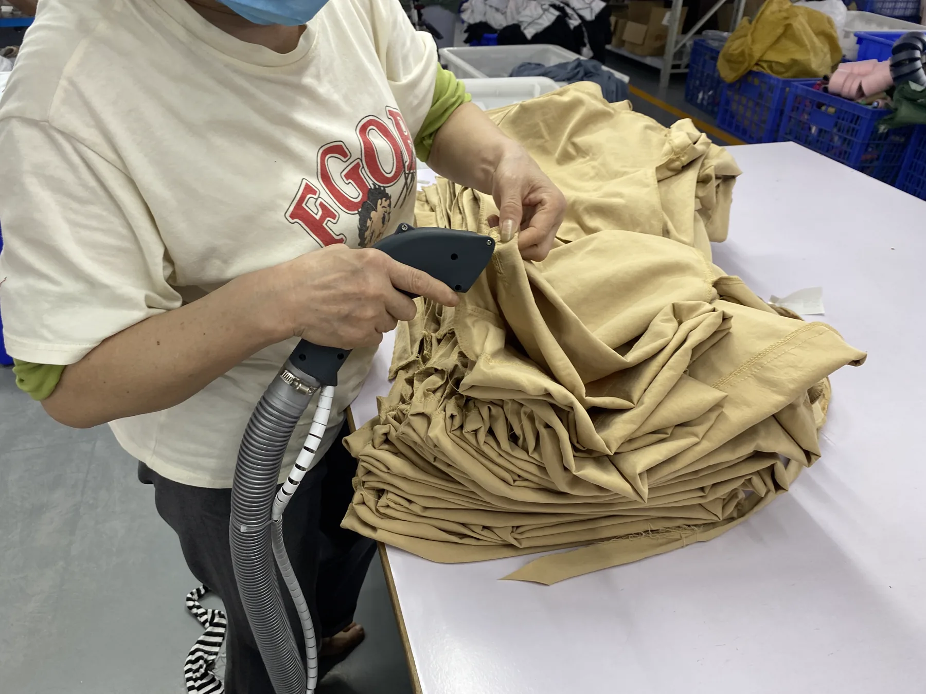 Close view of an operator reviewing garment details at the quality control table