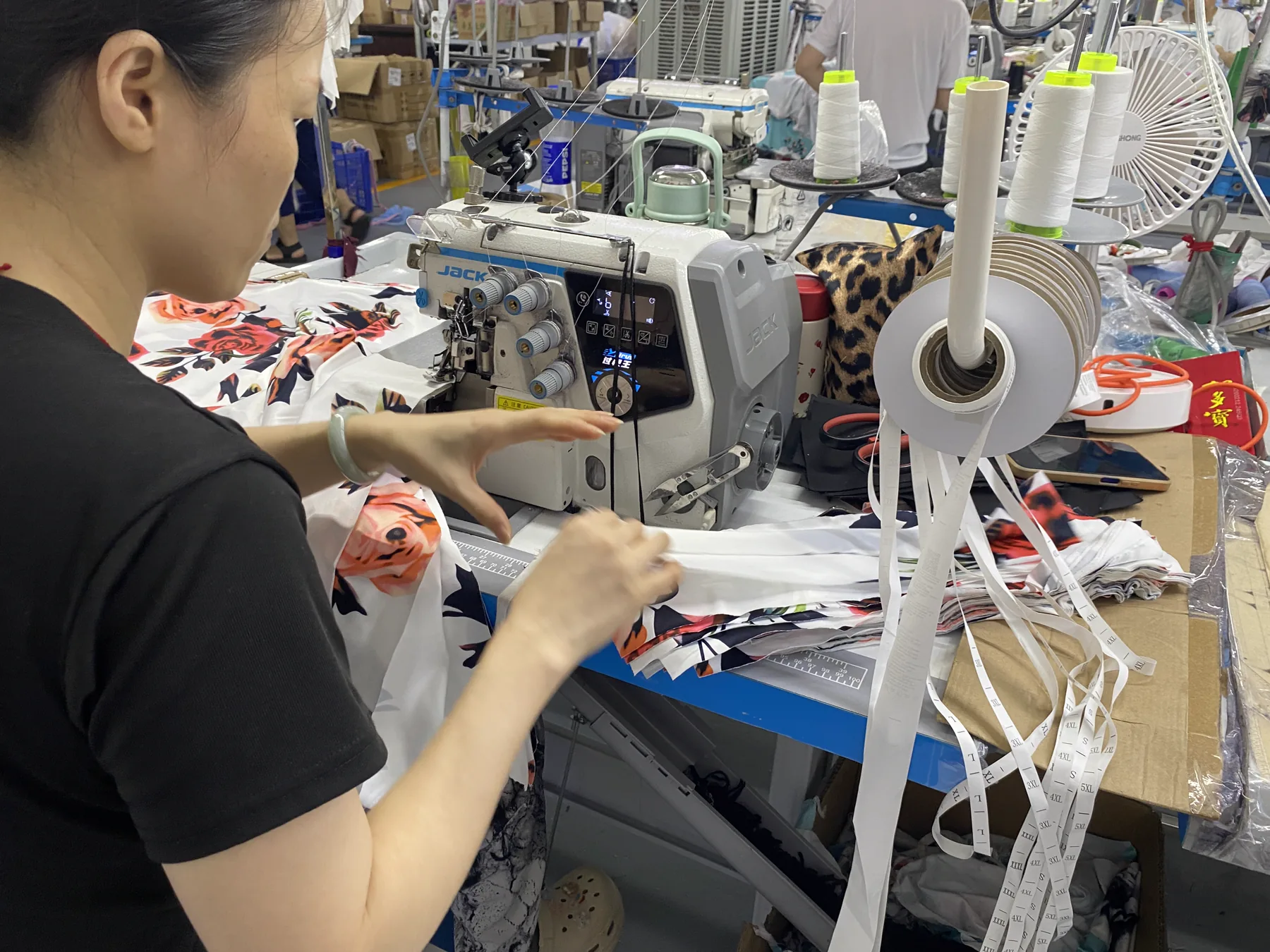 Operator sewing an overlock seam on custom apparel